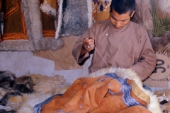 An Afghan artisan stitches sheepskin jackets in this coat shop, 1974. ©Peter Loud   peterloud.co.uk