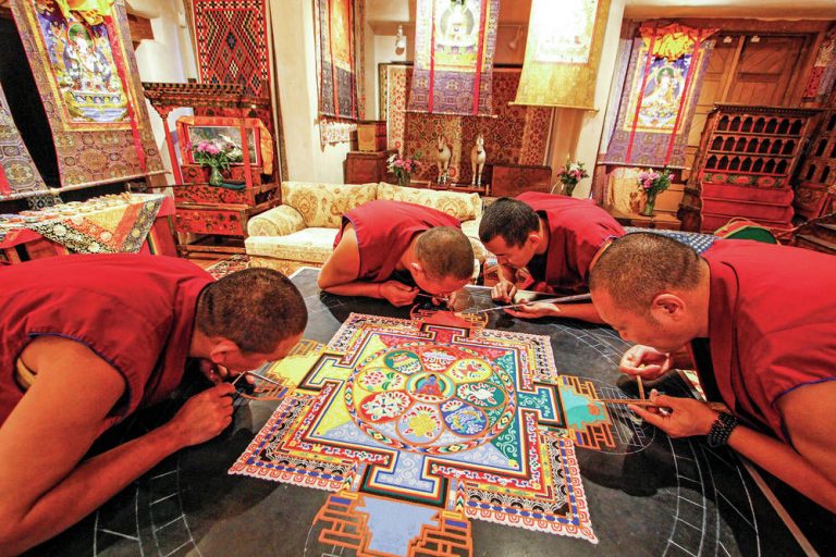 Monks of the Drepung Loseling Monastery pour millions of grains of sand to create a Sand Mandala at the Seret & Sons Gallery in Santa Fe, NM