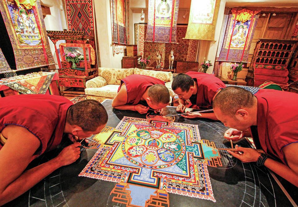 Monks of the Drepung Loseling Monastery pour millions of grains of sand to create a Sand Mandala at the Seret & Sons Gallery in Santa Fe, NM